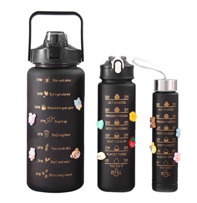 Set of three black water bottles with motivational text and colorful accents.